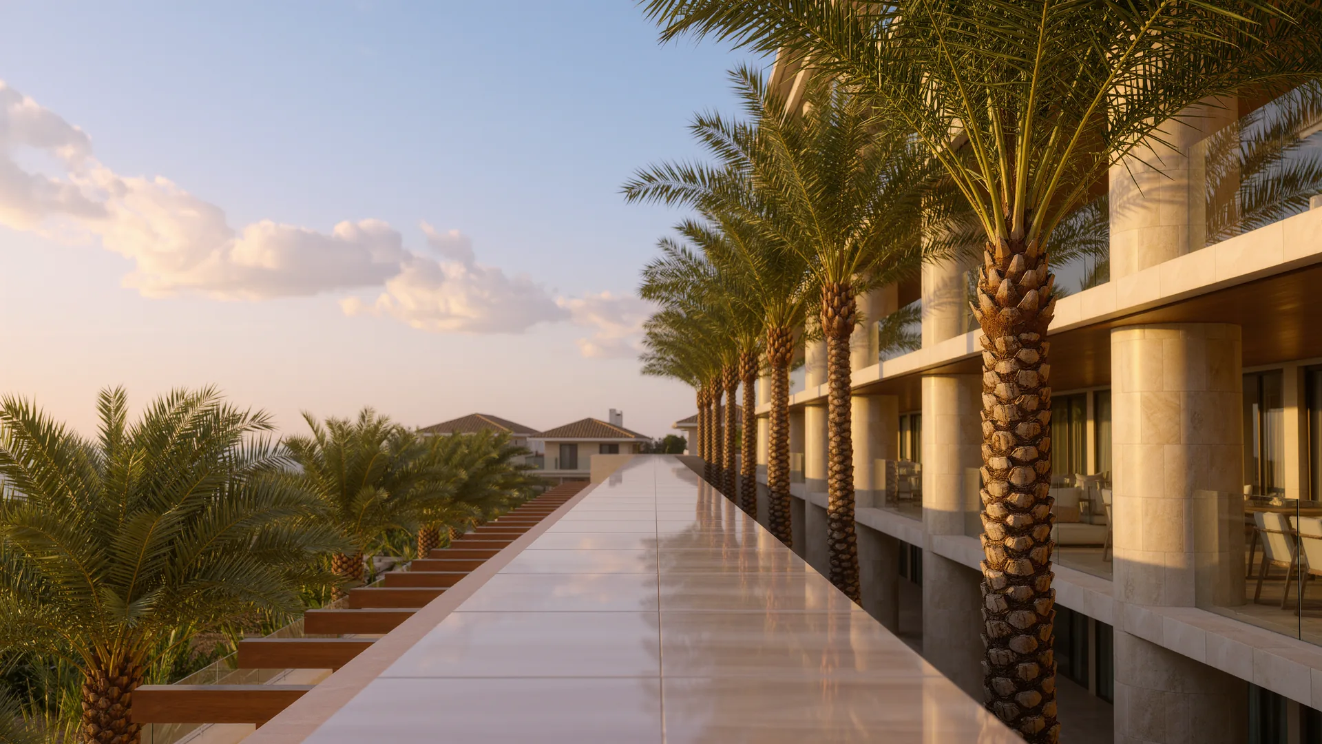 Apartment building courtyard with palms and a clean tiled walkway in morning light