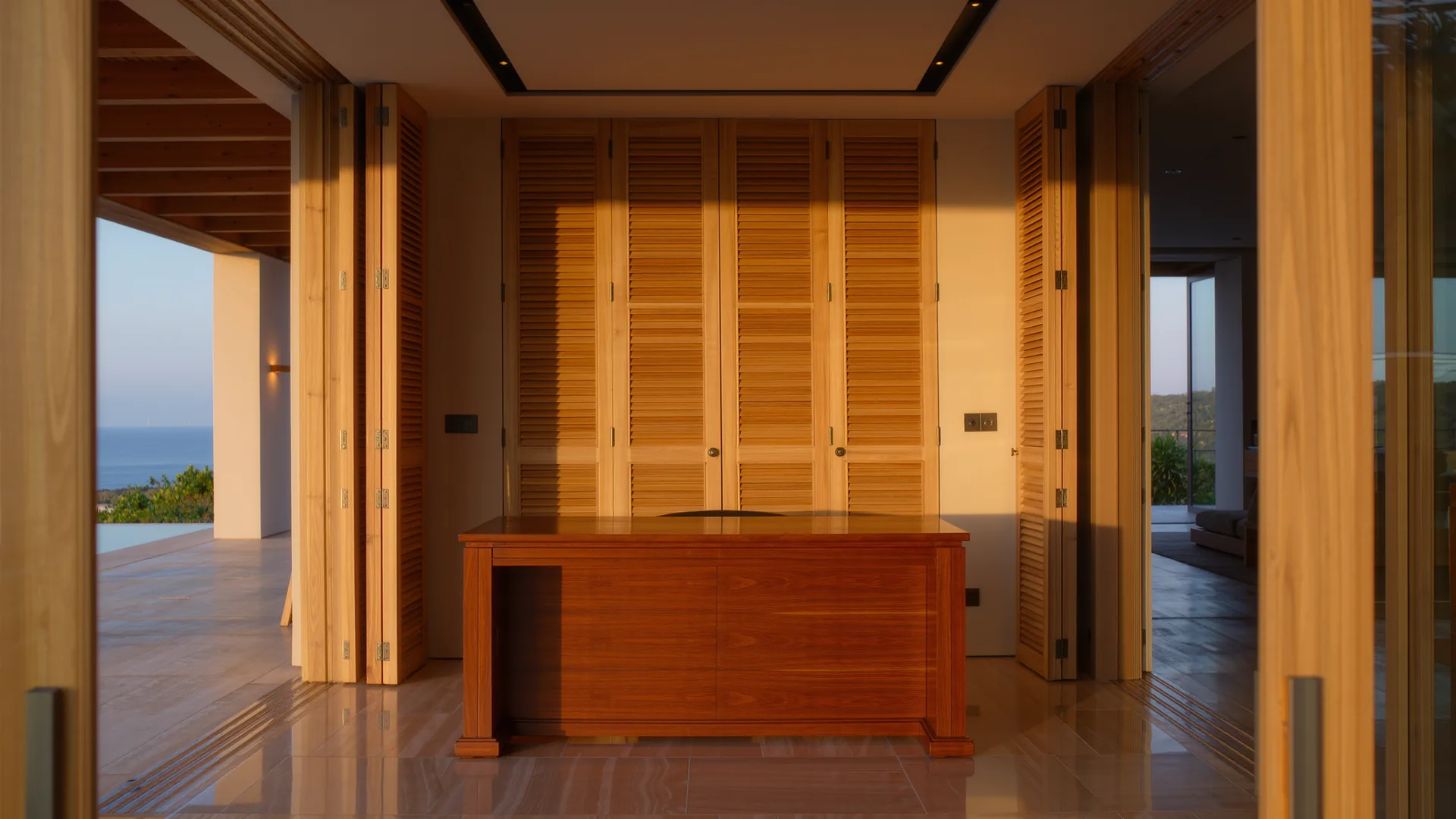 Bright private consulting room with a wooden desk and shutters