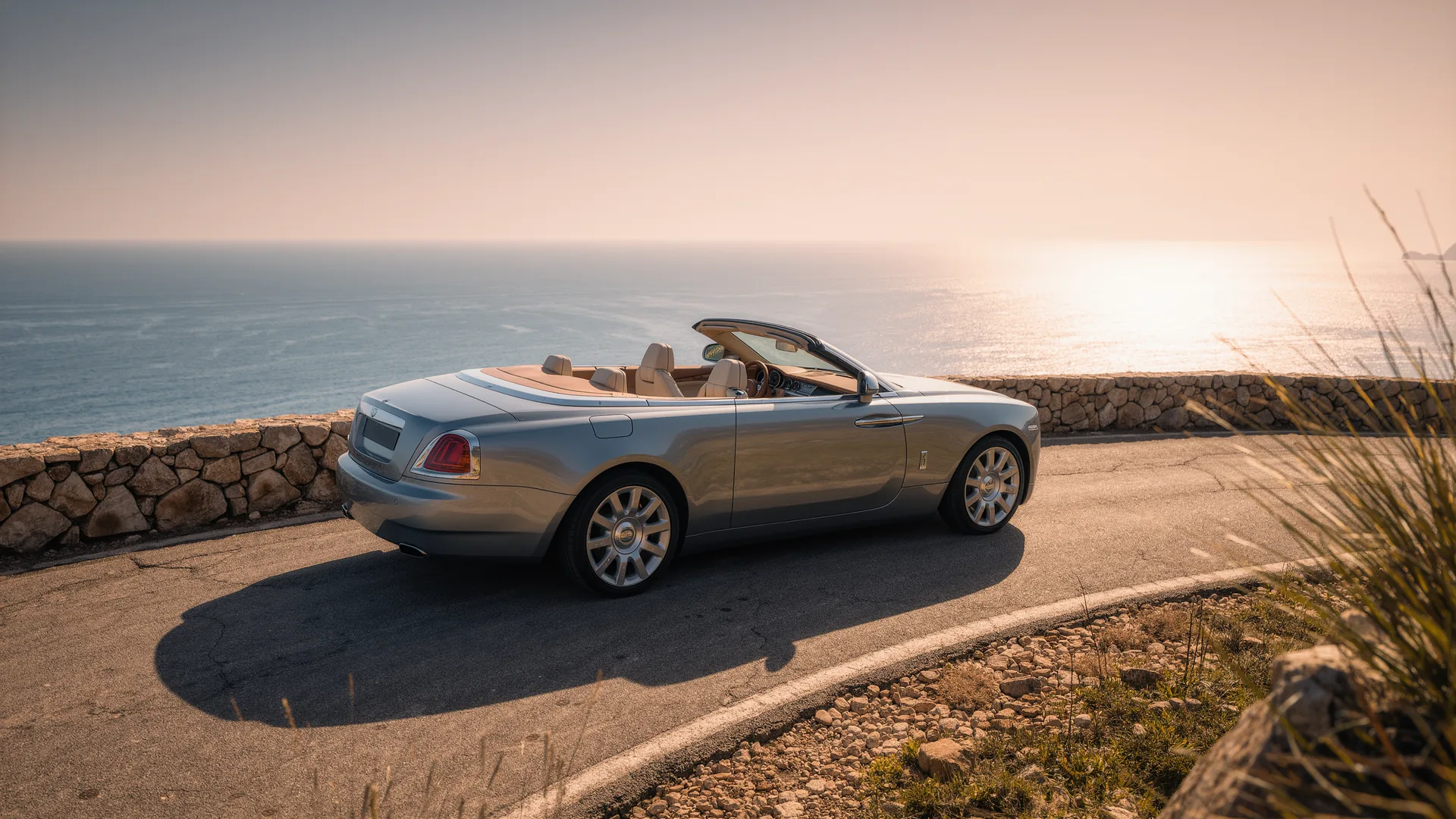 Convertible parked on a coastal road above the sea in Mallorca