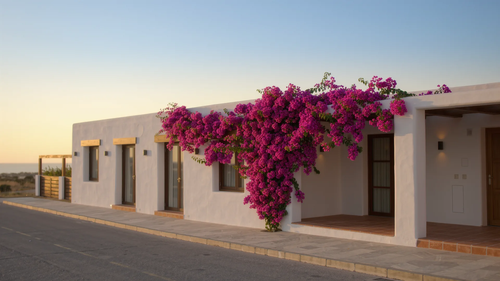 Andalusian white house with bougainvillea under a clear sky