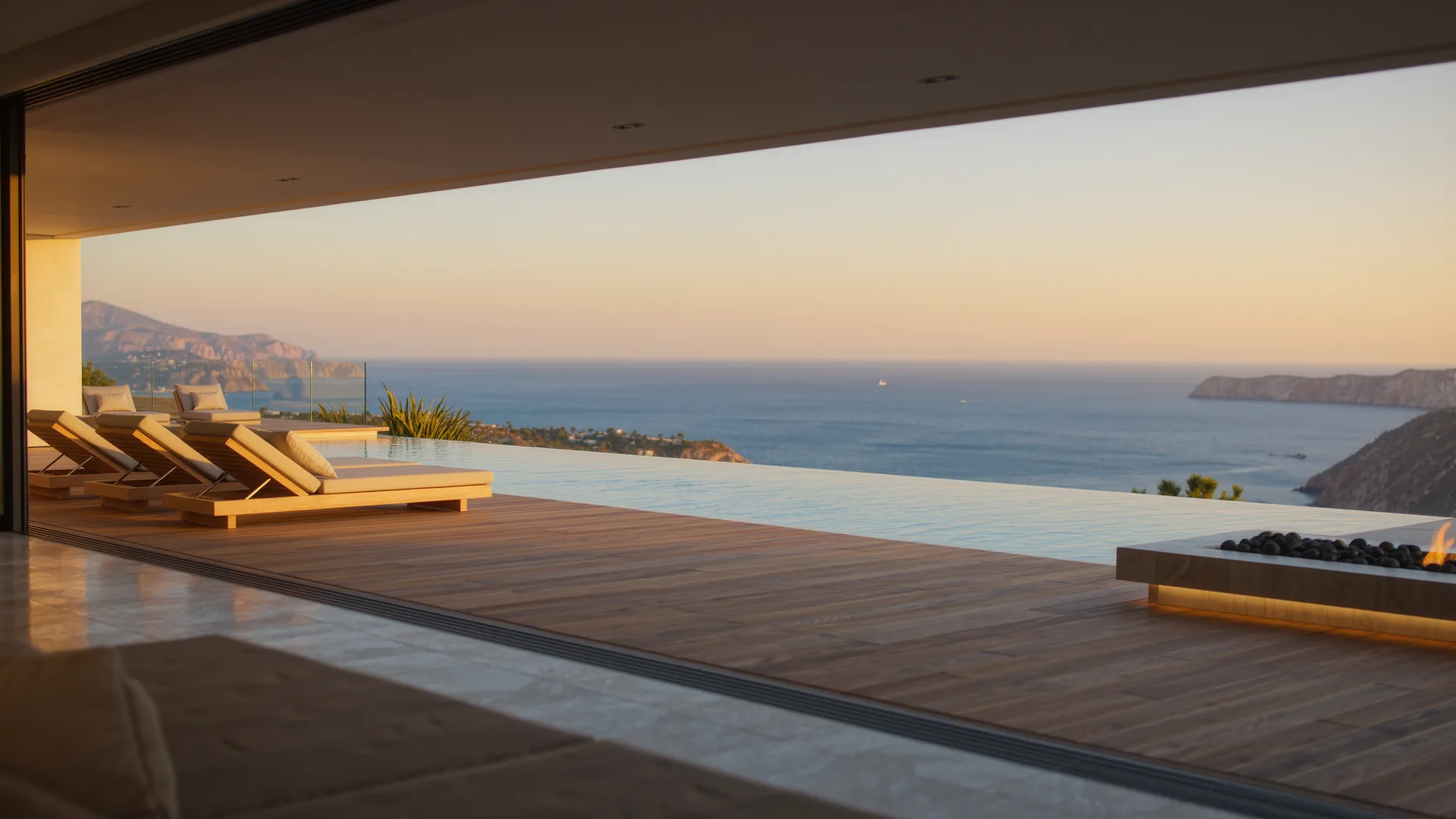 Modern villa terrace with an infinity pool above the Mediterranean at dusk