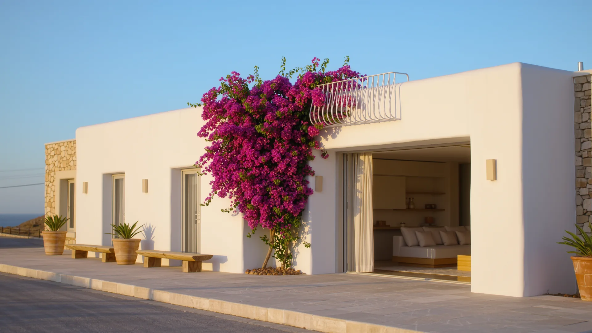 Andalusian white house with bougainvillea under a clear sky
