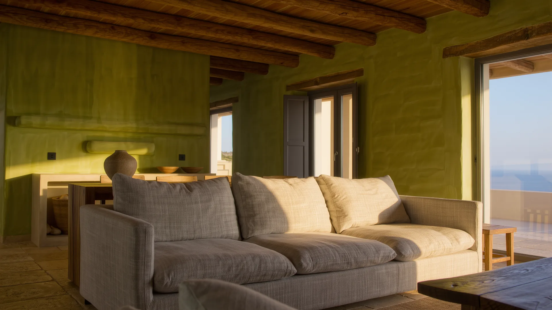 Mediterranean living room with lime plaster walls, a linen sofa and oak beams