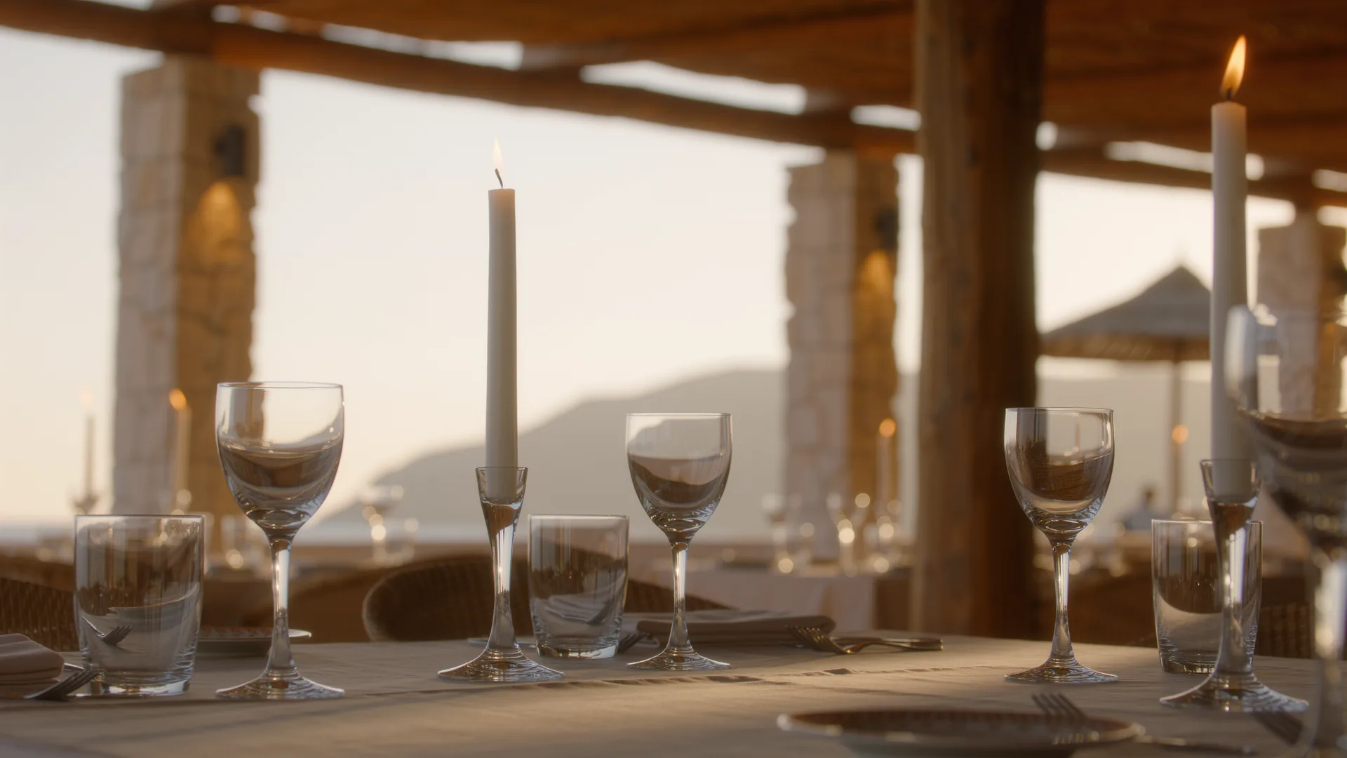 Elegant laid table with linen, crystal glasses and candlelight