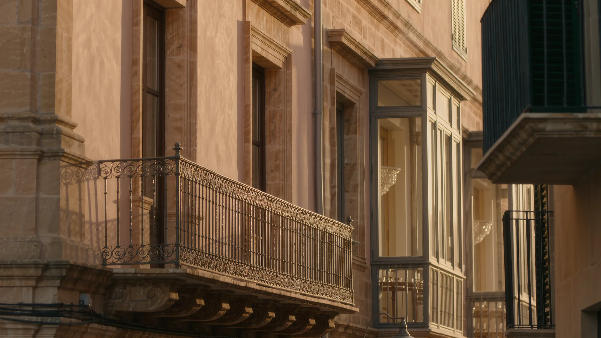 Old town street in Palma with sandstone facades and wrought iron balconies