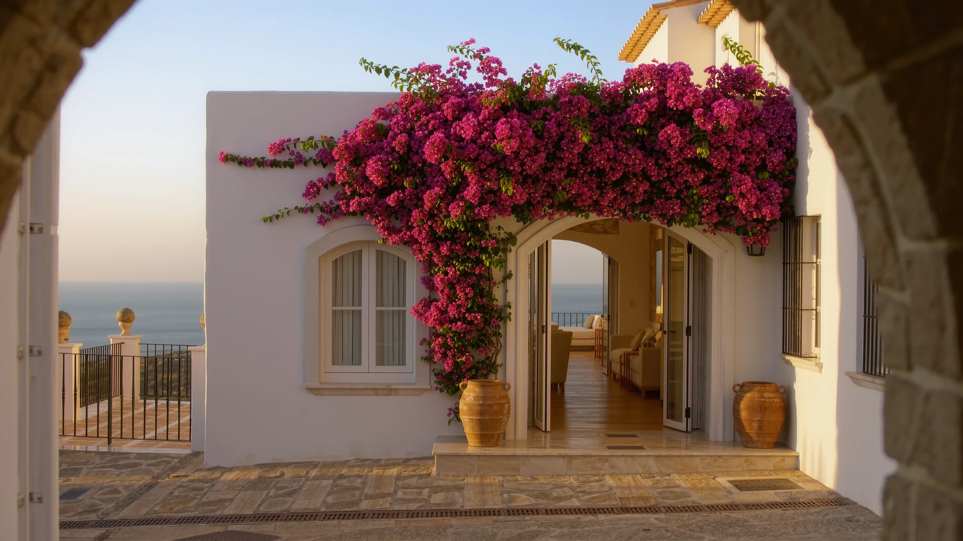 Andalusian white house with bougainvillea under a clear sky