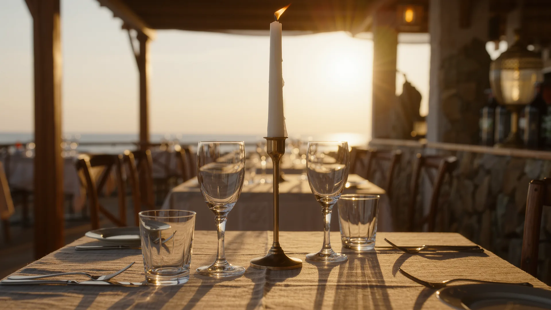 Elegant laid table with linen, crystal glasses and candlelight
