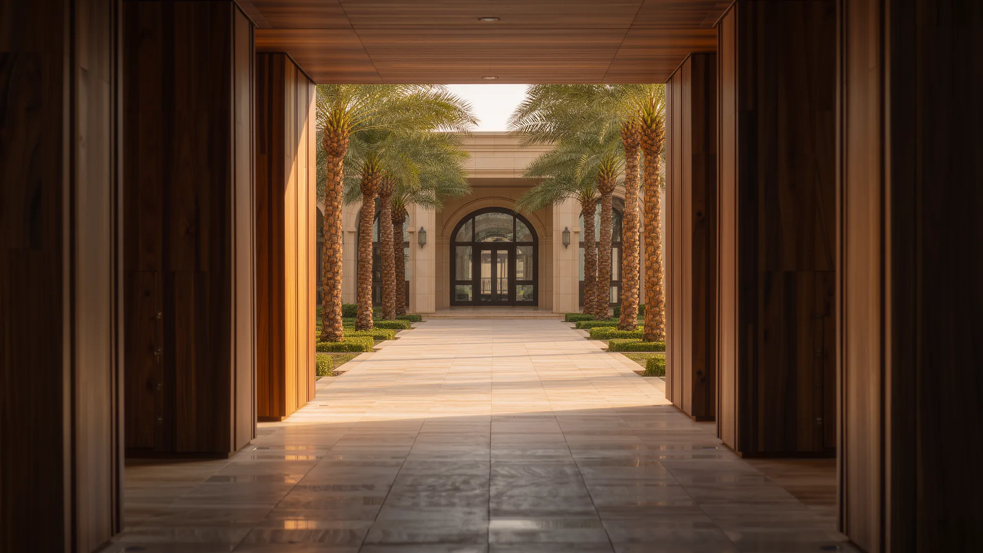 Apartment building courtyard with palms and a clean tiled walkway in morning light