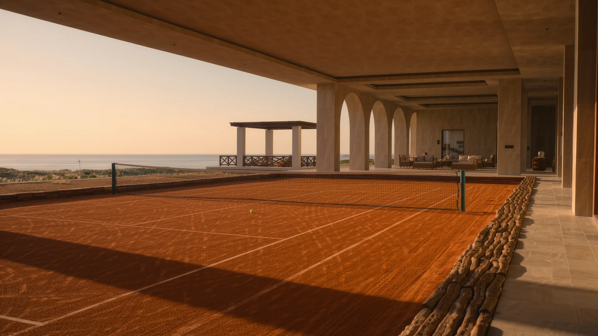 Clay tennis court freshly brushed, with long shadows
