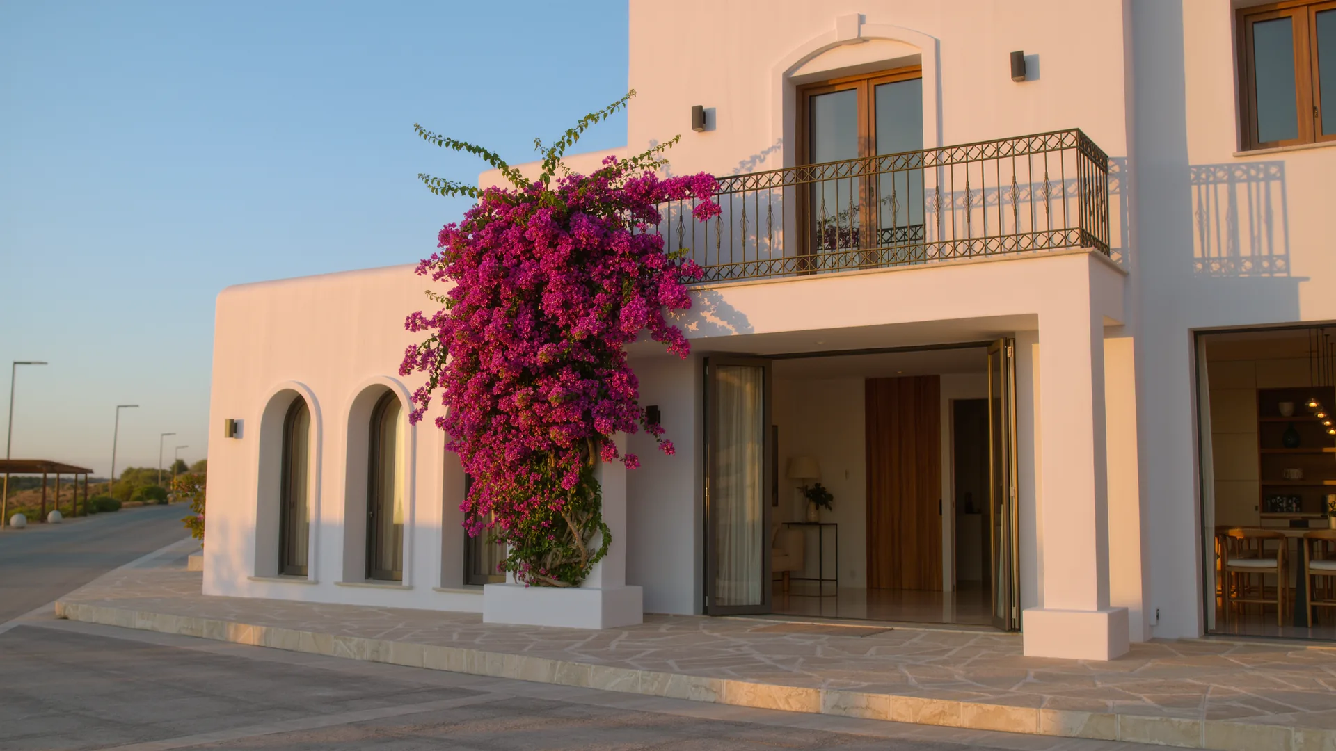 Andalusian white house with bougainvillea under a clear sky