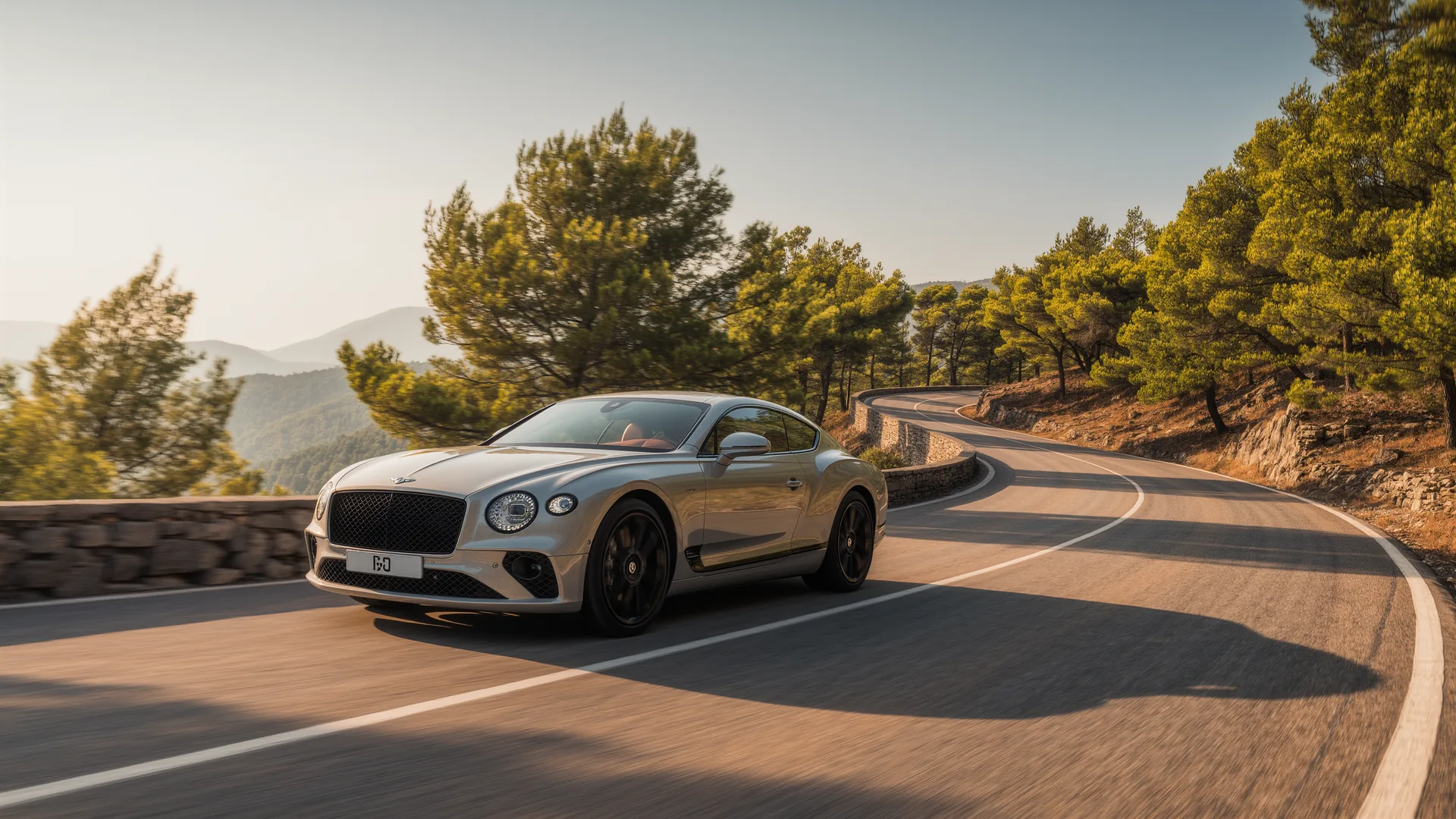 Car on a winding mountain road through pine trees